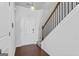 Inviting entryway features hardwood floors, staircase with wood railing, and modern light fixture at 813 Royal Red Ct, Mcdonough, GA 30253