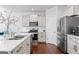 Spacious kitchen with stainless steel appliances, white cabinets, and an island with a sink at 813 Royal Red Ct, Mcdonough, GA 30253