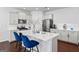 Bright kitchen featuring shaker cabinets, stainless appliances, large island, and hardwood floors at 813 Royal Red Ct, Mcdonough, GA 30253