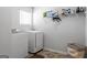 Efficient laundry room featuring a washer, dryer, storage, and bright natural light at 813 Royal Red Ct, Mcdonough, GA 30253