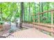Back yard showing deck and partial yard with many trees at 346 Buckingham Sw Dr, Conyers, GA 30094
