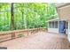 Expansive wooden back deck overlooking lush greenery, with screen porch at 346 Buckingham Sw Dr, Conyers, GA 30094