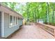Spacious back deck with wooden railing and trees in the background at 346 Buckingham Sw Dr, Conyers, GA 30094