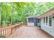 Wooden back deck and trees with screen porch at 346 Buckingham Sw Dr, Conyers, GA 30094