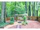Backyard features a cozy swing set with fire pit, surrounded by a wooden fence and lush greenery at 346 Buckingham Sw Dr, Conyers, GA 30094