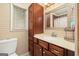 Bathroom featuring built-in storage, mirror, and a white sink and countertop at 346 Buckingham Sw Dr, Conyers, GA 30094