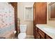 Cozy bathroom featuring a white toilet, built-in cabinet, and beach themed shower curtain at 346 Buckingham Sw Dr, Conyers, GA 30094