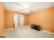 Bedroom with neutral carpet, orange walls, ceiling fan, and sheer white curtains at 346 Buckingham Sw Dr, Conyers, GA 30094