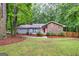 Charming ranch style home featuring stone accents and a vibrant red front door, nestled on a well-maintained lot at 346 Buckingham Sw Dr, Conyers, GA 30094