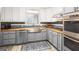 Modern kitchen with stainless steel appliances, gray cabinets, butcher block countertops, and stylish backsplash at 346 Buckingham Sw Dr, Conyers, GA 30094