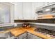 Close up of the kitchen featuring stainless steel appliances, butcher block countertops, and stylish gray and white cabinetry at 346 Buckingham Sw Dr, Conyers, GA 30094