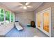 View of the screened porch with ceiling fan, seating, and access to backyard at 346 Buckingham Sw Dr, Conyers, GA 30094