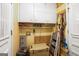 Storage area with white cabinets and assorted items at 346 Buckingham Sw Dr, Conyers, GA 30094