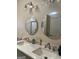 Bathroom with double sinks, framed round mirrors, and modern lighting at 329 Harris Ave, Locust Grove, GA 30248