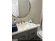 Bright bathroom features a granite vanity, a mirror, and a toilet with white subway tiled shower at 329 Harris Ave, Locust Grove, GA 30248