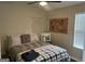 Comfortable bedroom features a ceiling fan, hardwood floors, and a full-sized bed with pillows at 329 Harris Ave, Locust Grove, GA 30248