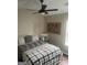 Comfortable bedroom features a ceiling fan, hardwood floors, and a full-sized bed with pillows at 329 Harris Ave, Locust Grove, GA 30248