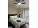 Cozy bedroom features a ceiling fan, hardwood floors, a window with blinds, and a full-sized bed at 329 Harris Ave, Locust Grove, GA 30248