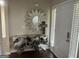 Inviting entryway featuring a unique accent table, sunburst mirror, and natural light at 329 Harris Ave, Locust Grove, GA 30248