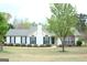 Charming one-story home with blue shutters and well-manicured lawn at 329 Harris Ave, Locust Grove, GA 30248