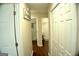 Hallway with hardwood floors and several entryways into different rooms at 329 Harris Ave, Locust Grove, GA 30248