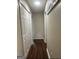 Hallway with hardwood floors, white trim, and neutral paint at 329 Harris Ave, Locust Grove, GA 30248