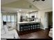 Open kitchen featuring a breakfast bar, stainless steel appliances, and connecting dining area at 329 Harris Ave, Locust Grove, GA 30248