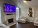 Cozy living room features vaulted ceilings, fireplace, and a large television at 329 Harris Ave, Locust Grove, GA 30248
