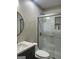 Clean bathroom features a glass shower stall, granite vanity, toilet and subway tile surround at 329 Harris Ave, Locust Grove, GA 30248