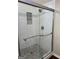 Modern shower stall with glass door, gray pebble floor and white subway tile with a built-in niche at 329 Harris Ave, Locust Grove, GA 30248