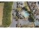 Aerial view of neighborhood featuring pool, mature trees, clubhouse, and community tennis court at 807 Stickley Oak Way, Woodstock, GA 30189