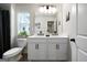 Charming bathroom with double vanity, white cabinets, large mirror, and ample counter space at 807 Stickley Oak Way, Woodstock, GA 30189