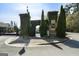 Welcoming gated entrance with ivy-covered stone pillars and lush landscaping adds an elegant touch to the community at 807 Stickley Oak Way, Woodstock, GA 30189