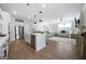 Open-concept kitchen and living room with hardwood floors and plenty of natural light at 807 Stickley Oak Way, Woodstock, GA 30189