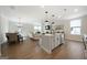 Open-concept living space featuring a kitchen, dining area, and comfortable living room furniture at 807 Stickley Oak Way, Woodstock, GA 30189