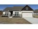Charming single-Gathering home featuring a two-car garage, brick accents, and neutral paint scheme at 587 Cantrell Drive, Dallas, GA 30157