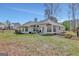 Expansive backyard with patio, lush green grass, mature trees, and ample room for outdoor activities at 147 Kripple Kreek Dr, Sharpsburg, GA 30277