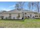Spacious backyard offers a patio area perfect for outdoor dining and entertaining, with lush green grass at 147 Kripple Kreek Dr, Sharpsburg, GA 30277