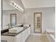 Elegant bathroom with dual vessel sinks, a large mirror, and a soaking tub under a window at 147 Kripple Kreek Dr, Sharpsburg, GA 30277
