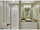 Bathroom featuring a stylish vessel sink, framed mirror, and a bright white shower with sliding glass door at 147 Kripple Kreek Dr, Sharpsburg, GA 30277