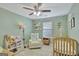 Charming Bedroom with a wooden crib, cozy armchair, and playful decor for a warm atmosphere at 147 Kripple Kreek Dr, Sharpsburg, GA 30277