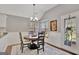 Bright dining area with a round wood table, stylish light fixture, and a door to the outside at 147 Kripple Kreek Dr, Sharpsburg, GA 30277