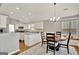 Open concept dining room with modern chandelier, table and eat-in kitchen at 147 Kripple Kreek Dr, Sharpsburg, GA 30277
