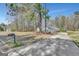 Charming home featuring a long driveway, mature trees, and a well-manicured front lawn at 147 Kripple Kreek Dr, Sharpsburg, GA 30277