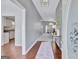 Open foyer with hardwood flooring, a view into the living room, and a glimpse of the kitchen at 147 Kripple Kreek Dr, Sharpsburg, GA 30277