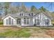 Bright white home with detailed windows and a light blue front door at 147 Kripple Kreek Dr, Sharpsburg, GA 30277