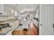 Bright kitchen featuring white cabinets, stainless steel appliances, and granite countertops at 147 Kripple Kreek Dr, Sharpsburg, GA 30277
