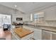 Charming kitchen featuring a center island, stainless steel appliances, and granite counters at 147 Kripple Kreek Dr, Sharpsburg, GA 30277