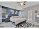 Cozy primary bedroom showcases a blue accent wall, plush bedding, and ambient lighting at 147 Kripple Kreek Dr, Sharpsburg, GA 30277