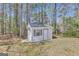 Backyard features a small shed with a ramp and a single window, ideal for storage or a workshop at 147 Kripple Kreek Dr, Sharpsburg, GA 30277